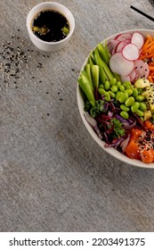 Overhead View Of Hawaiian Poke Bowl With Chopsticks And Soy Sauce On Grey Background. Hawaiian Tasty Fresh Food And Healthy Eating.