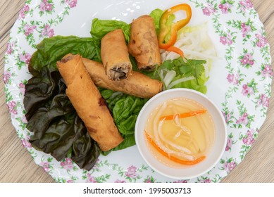 Overhead View Of Hearty Appetizer Of Deep Fried Egg Rolls Cooked To Crispy Perfection Served With Dipping Sauce.