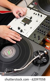 Overhead View Of Hip Hop DJ Scratching Vinyl Record With Music On Turntable Records Player.Focus On Hands Of Disc Jockey Playing.Professional Analog Audio Equipment