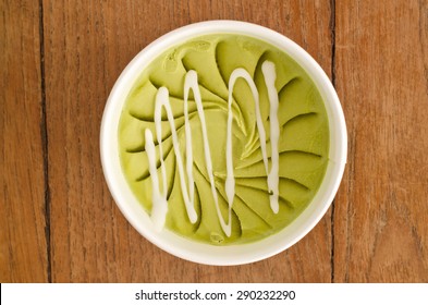 Overhead View Of  Homemade Green Tea  Italian Ice Cream Tub On Wooden Background