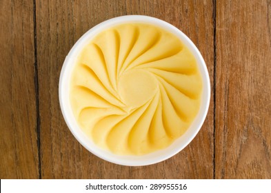 Overhead View Of  Homemade Mango Italian Ice Cream Tub On Wooden Background