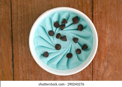 Overhead View Of  Homemade Mint And Chip  Italian Ice Cream Tub On Wooden Background