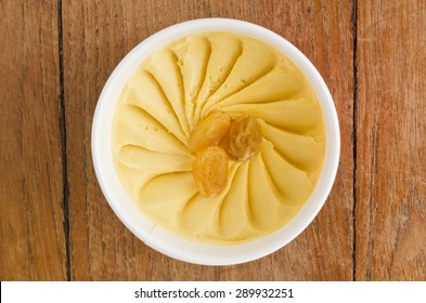 Overhead View Of  Homemade Rum Raisin Italian Ice Cream Tub On Wooden Background