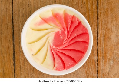 Overhead View Of  Homemade Strawberry  With Banana Italian Ice Cream Tub On Wooden Background