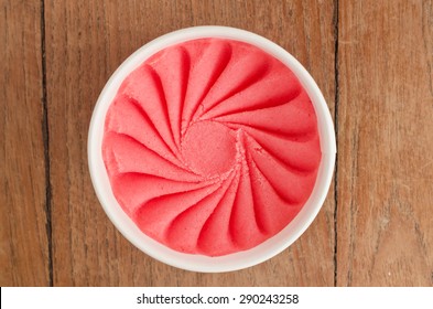 Overhead View Of  Homemade Strawberry Italian Ice Cream Tub On Wooden Background