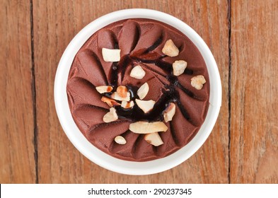 Overhead View Of  Homemade Walnut Italian Ice Cream Tub On Wooden Background