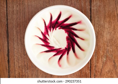 Overhead View Of  Homemade Yoghurt Blueberry Italian Ice Cream Tub On Wooden Background