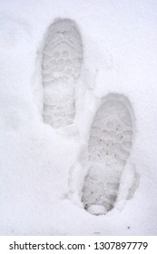 Overhead View Of Human Footprints On White Winter Snow Background.