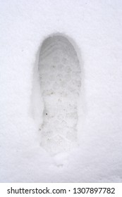 Overhead View Of Human Footprints On White Winter Snow Background.