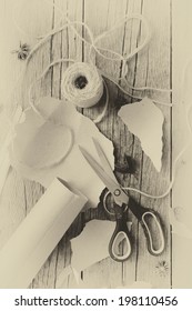 Overhead view of items ready to wrap gifts including brown paper and twine for Christmas or other holiday or occasion with vintage effect