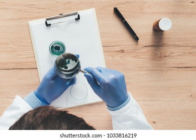 Overhead View Of Laboratory Technician Analyzing Growing Bacterial Cultures In Petri Dish, Science And Microbiology Background