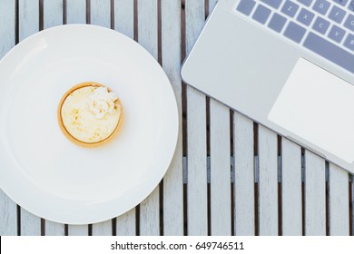 Overhead View Of Laptop And Desserts Outside