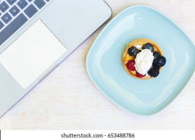 Overhead View Of Laptop And Desserts Outside