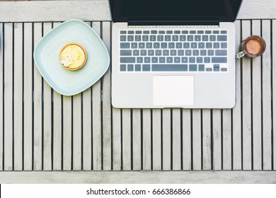 Overhead View Of Laptop And Desserts Outside