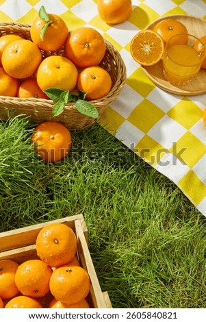 Overhead view of a light brown rectangular wooden crate filled with fresh ripe oranges. The inside surface of the oranges are juicy orange segments with white lines dividing them. Nature concept
