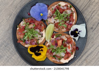 Overhead View Of Loaded Plate Of Ceviche Tacos Piled High With All The Fresh Seafood Ingredients.