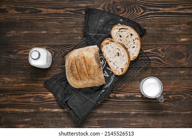 Overhead View Of Loaf Of Artisan Sourdough Bread With Porous Texture On Wooden Table