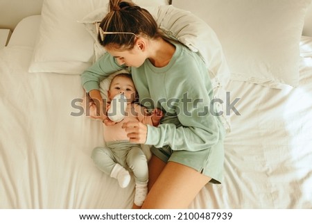 Similar – mother and child son sleeping together in bed