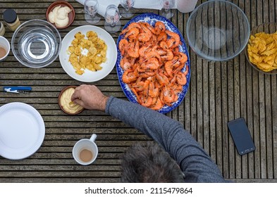 Overhead View Of Man Enjoying Prawns And Mayonnaise In An Outdoor Setting