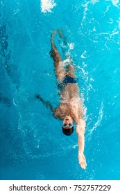 Overhead View Of Man Swimming On The Back In The Pool