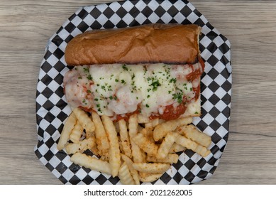 Overhead View Of Meatball Sub Sandwich Served With French Fries Will Fill Any Appetite With The Melted Cheese.