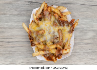 Overhead View Of Melted Cheese Smothers This Entire Boat Of Chile Cheese French Fries As A Very Filling Side Dish.