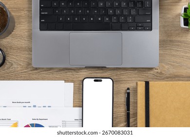 Overhead view of modern workspace featuring laptop, coffee, smartphone, documents, and notebook on a wooden desk