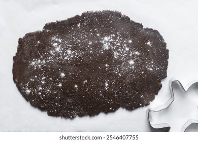 Overhead view of molasses cookie dough being rolled out on a marble countertop, top view of gingerbread cookie dough, process of making christmas cookies - Powered by Shutterstock