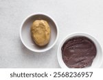 Overhead view of mooncake dough and red bean paste in a white plate, top view of mooncake dough and sweet adzuki bean paste in a white plate, process of making mooncakes