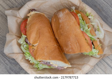 Overhead View Of Mouth Watering Roast Beef Sandwich Loaded With Melted Pepper Jack Cheese And Wrapped In A Freshly Baked Italian Roll For A Hearty Meal.