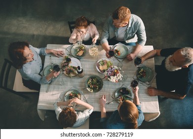 overhead view of multigeneration family having dinner together at home - Powered by Shutterstock