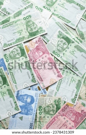 Overhead view of Naira notes, top view of Nigerian 1000 500 and 200 Naira notes on a white surface