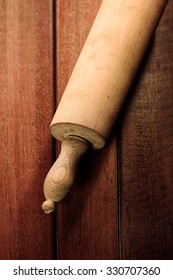 Overhead View Of An Old Wooden Rolling Pin On A Kitchen Table In A Concept Of Baking And Cooking Food