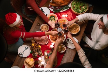 Overhead view on family sitting around christmas table with traditional Christmas roast