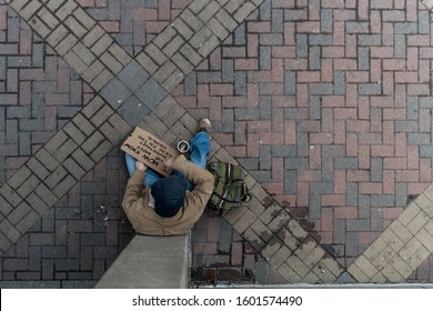 Overhead View Of A Panhandler Sitting 