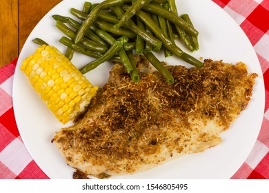 Overhead View Of Parmesan Crusted Flounder Fillet Dinner In Country Kitchen Setting