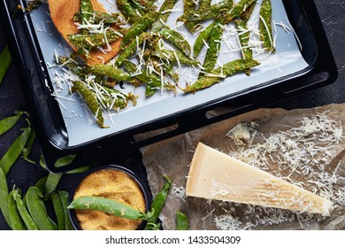 Overhead View Of Parmesan And Polenta Breaded Snap Peas Roasted In A Baking Pan. Ingredients On A Concrete Table, View From Above, Flatlay