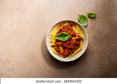 Overhead View Of Pasta Penne Bolognese And Basil Leaves