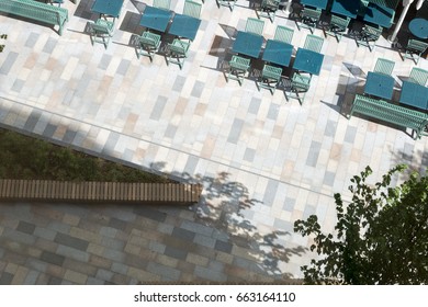 Overhead View Of A Paved City Walkway With Sidewalk Restaurant Furniture