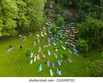 Overhead View Of People Do Yoga At City Public Park