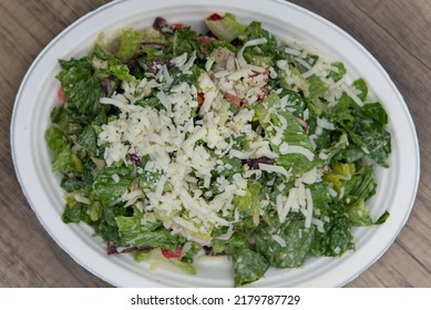 Overhead View Of Pepper Jack Cheese Tops This Enormous Chicken Caesar Salad With All The Chopped Ingredients To Fullfill Any Appetite.