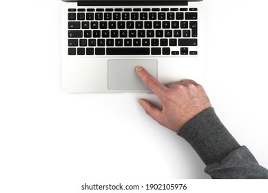 overhead view of person using touchpad or trackpad on laptop computer on white background