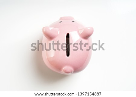 overhead view piggy or coin bank or piggybank or money box - finance and savings concept on white background with shadow