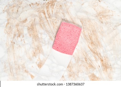 Overhead View Of A Pink Sponge Wiping Clean A Dirty Marble Floor Or Counter