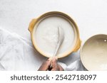 Overhead view of Plain rice congee in a clay pot, top view of rice porridge, chinese congee, korean juk or japanese okayu in a claypot