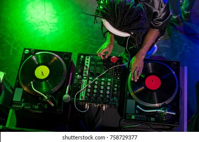 overhead view of professional african american DJ in headphones with sound mixer in nightclub  - Powered by Shutterstock