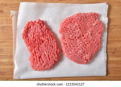 Overhead View Of Raw Cube Steaks On Wax Paper