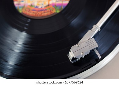 Overhead View Of A Record Player Tone Arm On A Spinning Vinyl Disc