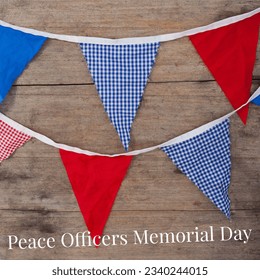 Overhead view of red and blue bunting with peace officers memorial day text on wooden table. digital composite, patriotism, identity and observance day concept. - Powered by Shutterstock