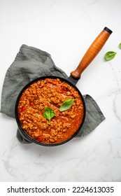 Overhead View Of Red Meat Sauce In Skillet Pan On Textile